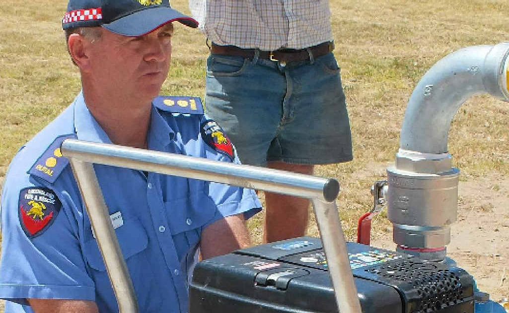 Deputy group officer Malcolm Stacey cranks up the pump at Massie Aerodrome yesterday. Deputy group officer Malcolm Stacey cranks up the pump at Massie Aerodrome yesterday.